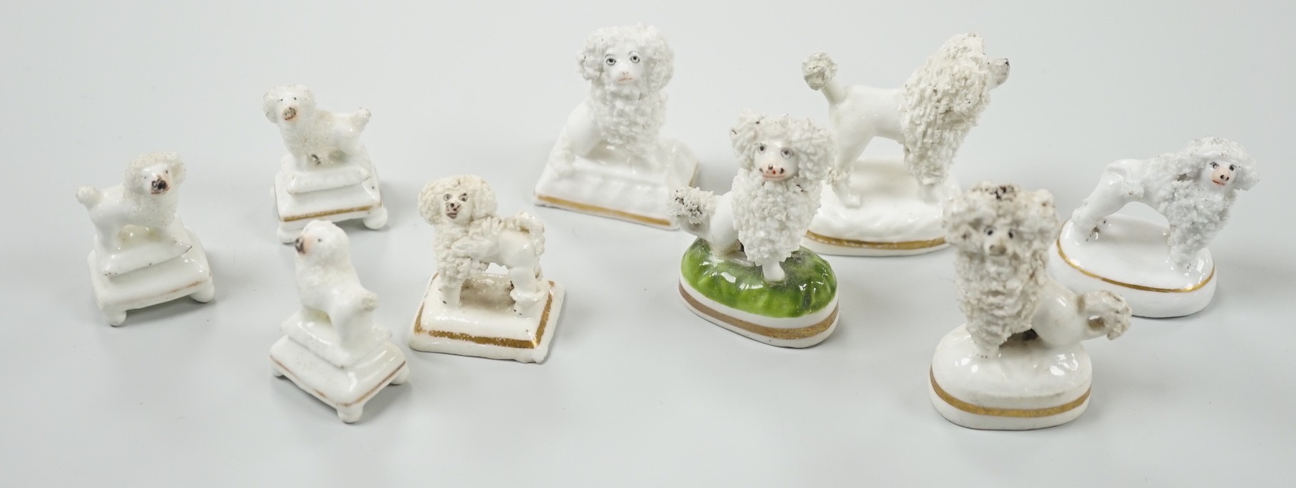 Four small Staffordshire porcelain models of poodles, together with five toy Staffordshire models of poodles, c.1830-50. Largest 5cm tall, Provenance- Dennis G Rice collection